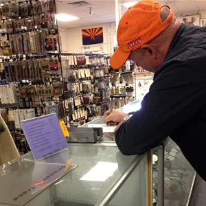 Mark Kelly in a Tuscon, Ariz., gun store (Captain Mark Kelly/Facebook)